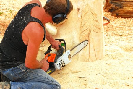 Chainsaw sculptures working on their creations at the annual Reedsport Oregon Chainsaw Sculpture Festival のeditorial素材