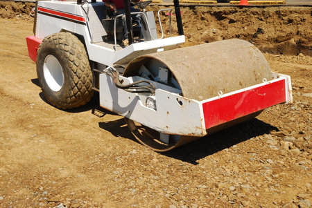 Compacting the soil during site prep with a vibration roller on a new business  project in Roseburg...