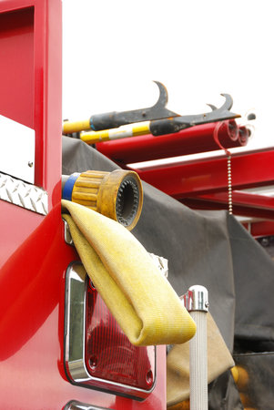 A fire nozzle awaits on a preconnected fire hose on a fire engine