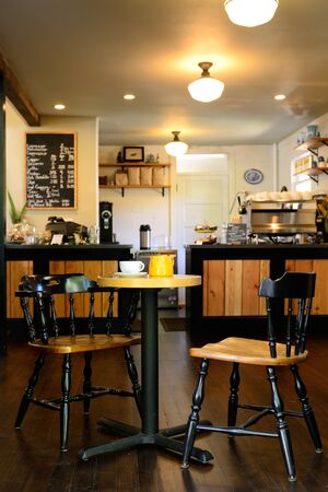 A young woman enjoys a fresh cup of tea at a tea house in a Northwest cityのeditorial素材