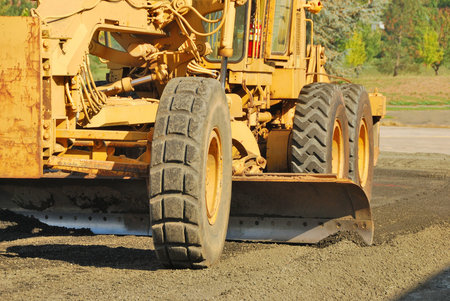 Land Grader working the building pad of a new tennis court in Roseburg Oregon at Stewart Park