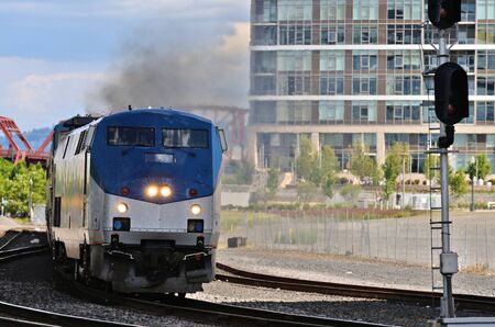 A passenger train leaves its station in a northwest USA cityのeditorial素材