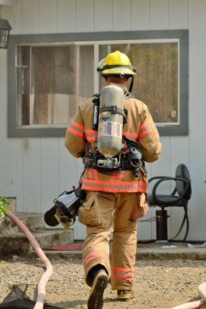 Roseburg, Oregon - July 31, 2013: Fire fighters respond to a structure fire in a residence that caused major interior damage.  No body was injured in the Roseburg, Oregon incident on July 13, 2013のeditorial素材