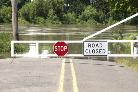 Gate closing the road, due to high water, to a river ferry crossing over the Willamette River near Salem Oregonの写真素材