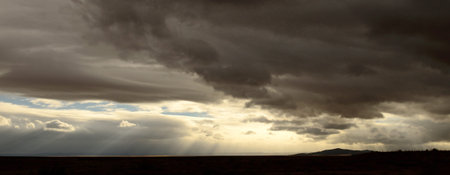 The high desert of northeastern Arizona as a rain storm rolls through along Intersate 40 as it  follows the original Route 66の写真素材