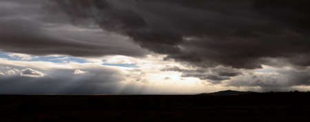 The high desert of northeastern Arizona as a rain storm rolls through along Intersate 40 as it  follows the original Route 66の写真素材