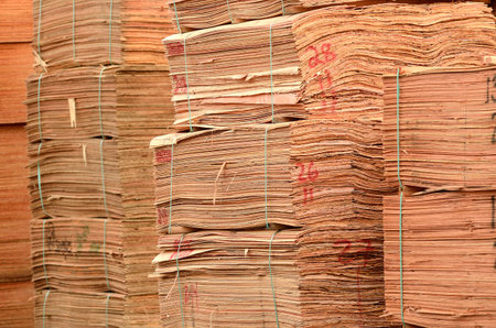 Stack of douglas fir veneer sits outside a mill that produces plywood panels