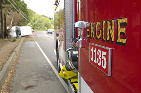 Roseburg, OR, USA - April 25, 2014: Fire fighers and police at a single vehicle accident that rolled and hit a powerpole and trees resulting in minor injuries to the driver.のeditorial素材