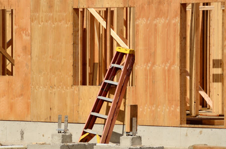 Small ladder leans against a newly constructed wall at a commercial residential development building