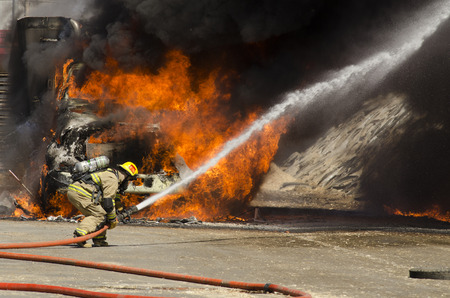 Fire fighters respond to a semi truck and silage fire at a dairy farm in Gustine, CA, on June 18, 2014のeditorial素材