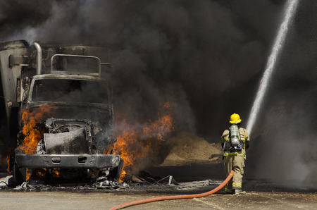 Fire fighters respond to a semi truck and silage fire at a dairy farm in Gustine, CA, on June 18, 2014のeditorial素材