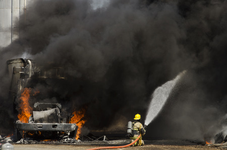 GUSTINE, CA, USA - JUNE 18, 2014: Fire fighters respond to a semi truck and silage fire at a dairy farm in Gustine, CA, on June 18, 2014のeditorial素材