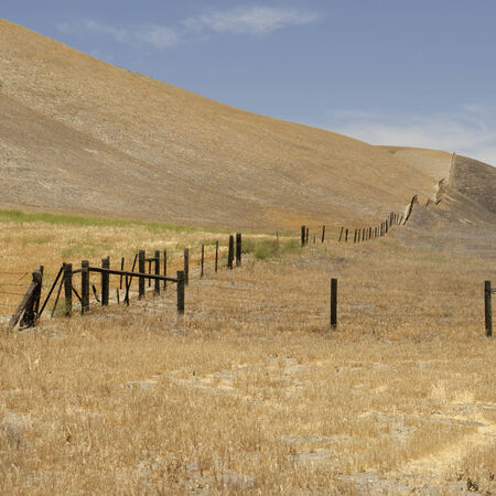 Large pasture light grass pasture and fence on a cattle ranch in southwestern Californiaの写真素材