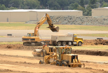 equipment working at a construction site to extend an airport runway.