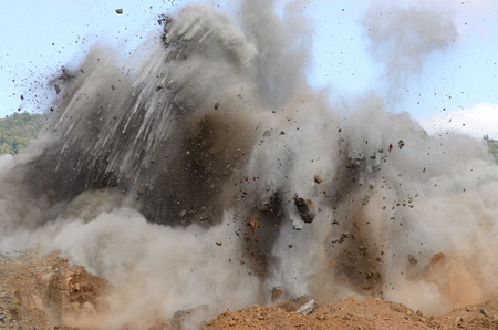 A sequence of images of a blasting operation of a rock hill to make way for an airport runway expansion project.の写真素材