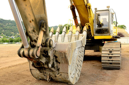A large tracked excavator at an construction siteの写真素材