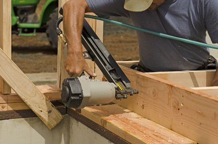 Framing building contractor framing up a wall section for a luxury custom houseの写真素材