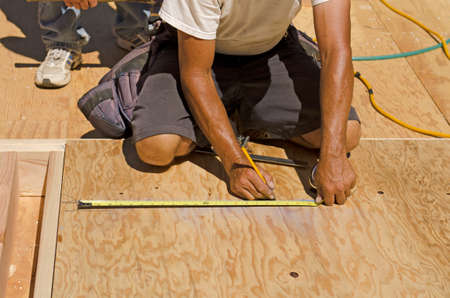 Framing Contractor cutting in a window or door opening in outside bearing wood stud wallの写真素材