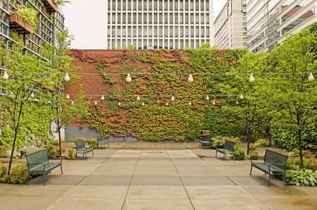 Great small park and eating area with ivy and brick in a downtown area of  Portland Oregonの写真素材