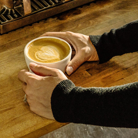 Shape of cream or milk into a fresh cup of latte