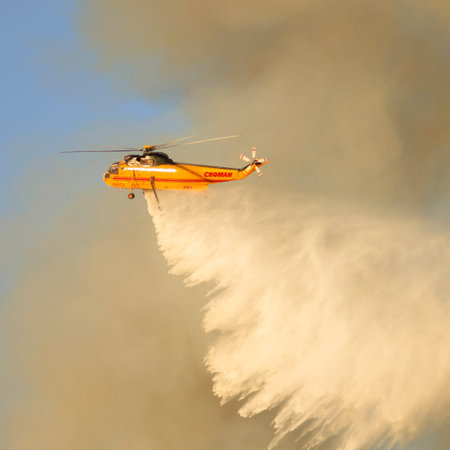 Roseburg, OR, USA - September 04, 2014: Fire fighers work with aviation helicopters to suppress a...