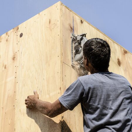 Framing construction contractor installing a beam pocket on a wood frame wall of a new luxury custom homeの写真素材