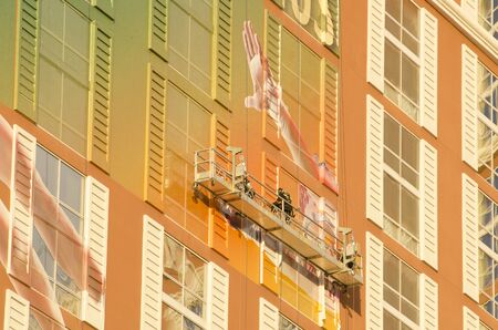 Las Vegas NV USA  November 11 2014: Workers applying a billboard ad wrap of a new show on the outside of the Mirage hotel and Casino in Las Vegasのeditorial素材