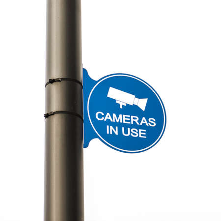 Camera in use sign in the parking lot of a large business complexの写真素材