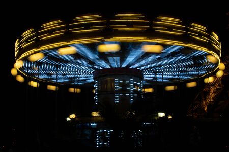 Carousel (merry-go-round) time lapse photo shot in late evening light at a carnival.の写真素材