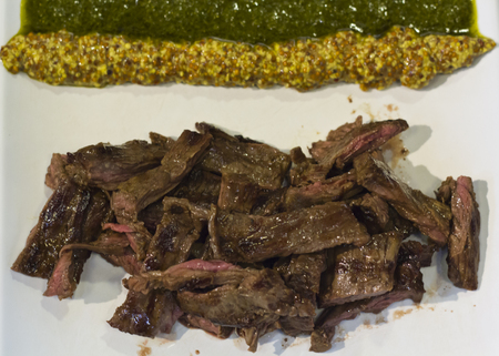 Juicy pieces of red meat with saucesの写真素材