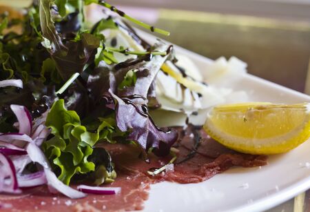Close-up of a fresh tasty salad on a white plateの写真素材