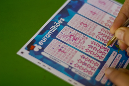 Hand filling out a lottery ticket Euromillionsのeditorial素材