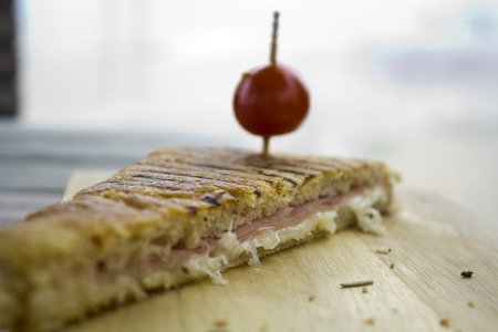 Ham and cheese mixed toast on a wooden boardの写真素材