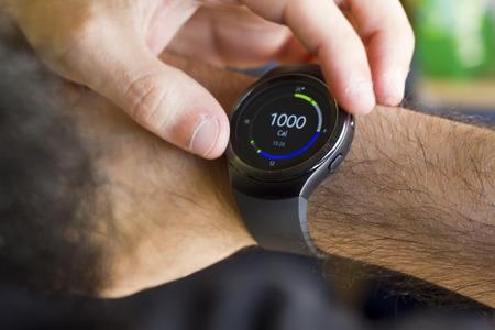 Man using smartwatch to count caloriesの写真素材