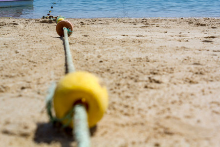 Low angle view of marker buoys rope on the beach