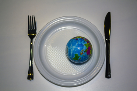 World on a plastic plate with plastic cuttleryの写真素材