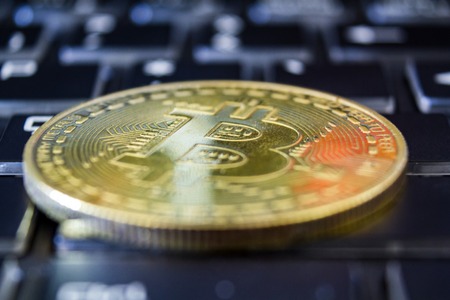 Golden bitcoin on keyboard. Trading concept of crypto currencyの写真素材