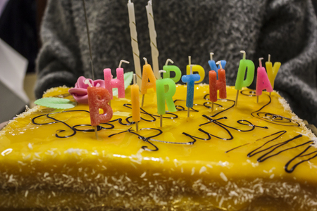 Unrecognizable woman holding a birthday cakeの写真素材