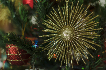 Golden star hanging on Christmas treeの写真素材