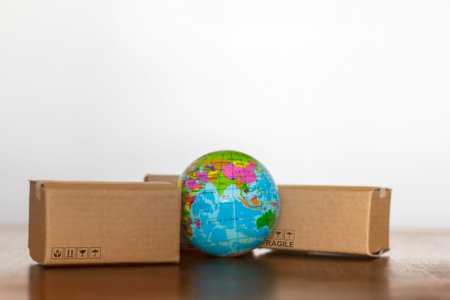 Carton and earth globe. Worldwide shopping and delivery business concept