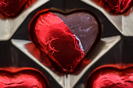 Top view of chocolate heart candies on box