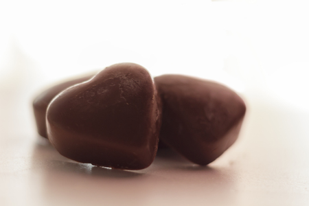 Chocolate heart candies on white backgroundの写真素材