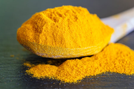 Wooden spoon with turmeric powder