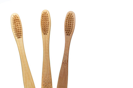 Wooden bamboo toothbrushes isolated on white background