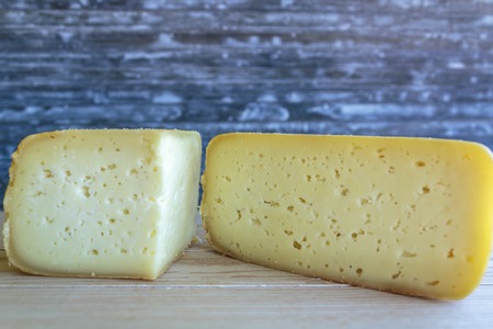 Artisanal portuguese cheese on wooden boardの写真素材