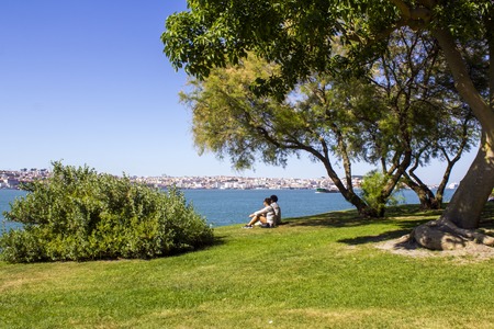 People at riverside park looking at viewの写真素材