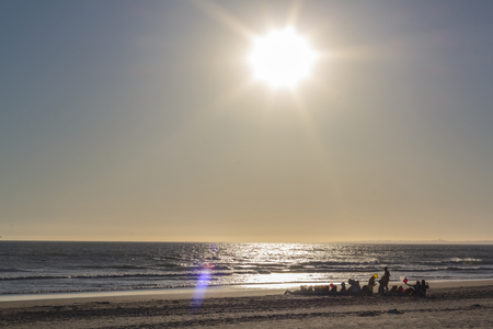 People on beach at sunsetの写真素材