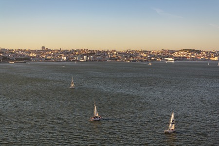 Lisbon, Portugal- CIRCA May 2019: Sailboats at tagus river with city of Lisbon on the backgroundの写真素材