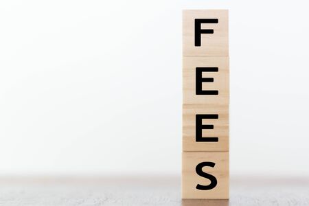 Fees word written on wooden cubes with copy spaceの写真素材