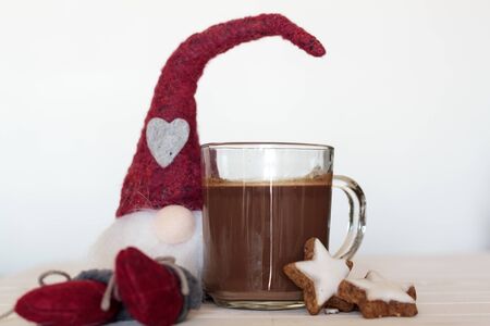 Cup of hot chocolate and cookies and Christmas gnome on the side. Winter holiday conceptの写真素材
